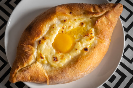 Caucasian Georgian cuisine, Adjarian khachapuri with fresh egg, top view flatly. High quality photoの写真素材