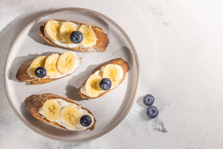 Banana sandwiches with blueberry on plate on table, flat lay, food on grey background with free space for text, Ingredientsの写真素材