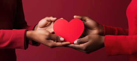 romance couple, man and woman hands holding red paper heart on red background, love Valentine Dayの素材