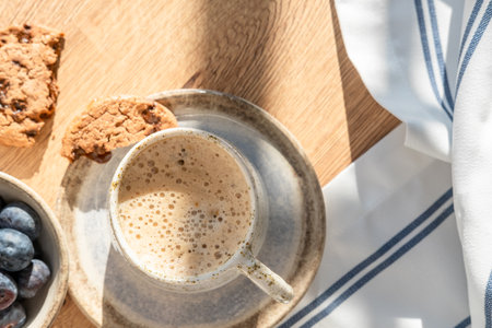 Coffee cup with blueberries and cookies served on wood table, coffe break concept, top vie, copy spaceの写真素材
