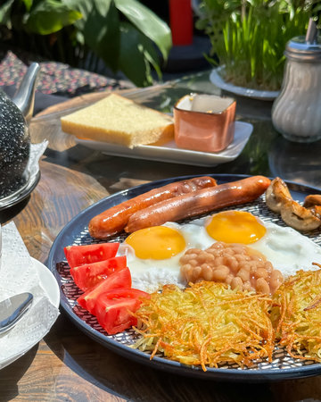 Enjoy a hearty breakfast with fluffy eggs, savory sausage, and other tasty treats to start your dayの写真素材