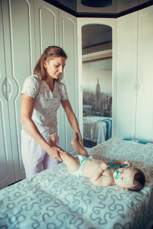 Masseur doing massage a small baby.の写真素材