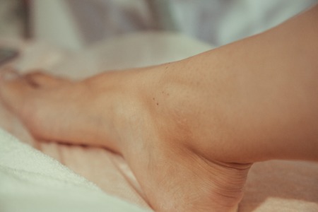 Laser hair removal on the leg in the cosmetology room. Close-up.の写真素材