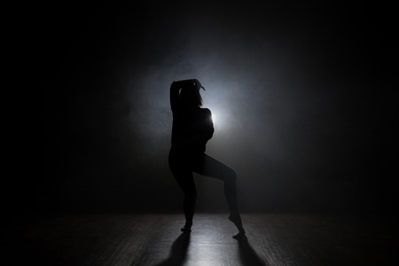 Silhouette of a dancer girl on a black backgroundの写真素材