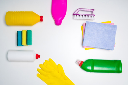 Range of cleaning products for the kitchen and bath. Detergents, chemical bottles, cleaning sponges and gloves. On a wooden table. view from above.の写真素材