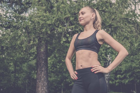 Portrait of a beautiful sports girl in black sports uniform.の写真素材