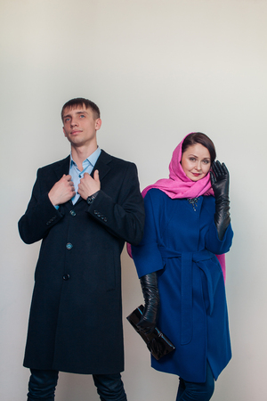 Stylish guy and attractive woman posing against white background autumn seasonの写真素材