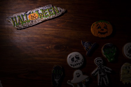 Holiday biscuits for Halloween of different shapes on a wooden table