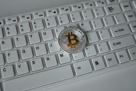 Coin bitcoin on the keyboard. Crypto currency. The concept of modern currency. Virtual business...