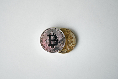 Silver and gold coins bit of a koin on a white background. Virtual currency. Crypto currencyの写真素材