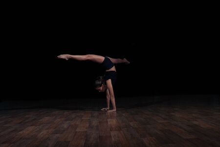 Girl gymnast doing the twine in the air. Sports gymnastics