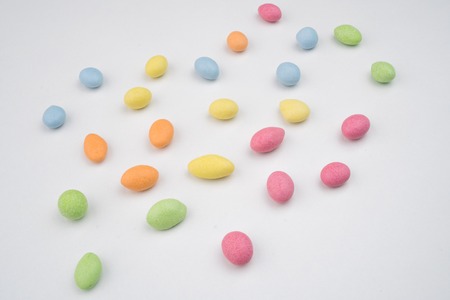 Multicolored sweets scattered on the white table