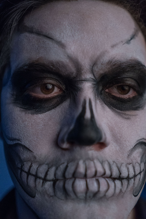Close-up portrait of a man with a dead mans face on halloween.