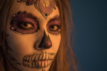 Close-up portrait of a girl with a dead mans make-up for Halloweenの写真素材