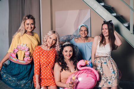The company of beautiful stylish girls at a bright party at homeの写真素材
