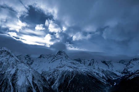 Beautiful mountain slopes with snow at sunsetの写真素材