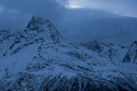 Beautiful mountain slopes with snow at sunsetの写真素材