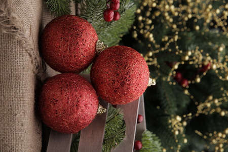 Christmas toys on a green Christmas tree with flashlightsの写真素材