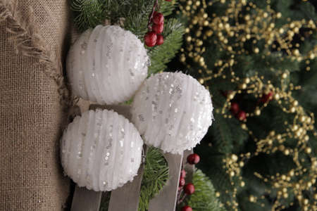 christmas toys on the background of a green Christmas tree with flashlightsの写真素材