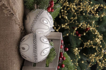 christmas toys on the background of a green Christmas tree with flashlightsの写真素材