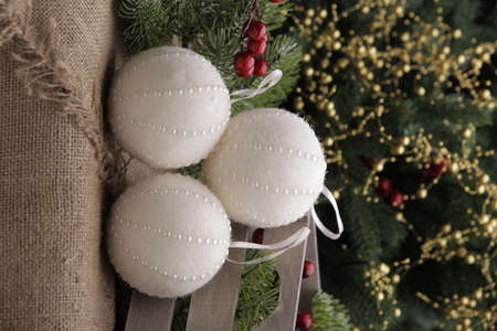 christmas toys on the background of a green Christmas tree with flashlightsの写真素材