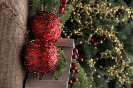 christmas toys on the background of a green Christmas tree with flashlightsの写真素材