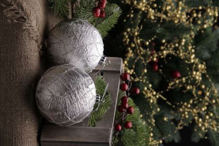 christmas toys on the background of a green Christmas tree with flashlightsの写真素材