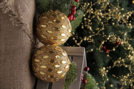 christmas toys on the background of a green Christmas tree with flashlightsの写真素材