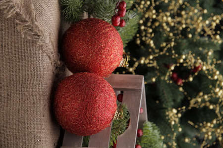 christmas toys on the background of a green Christmas tree with flashlightsの写真素材