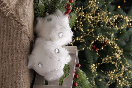 christmas toys on the background of a green Christmas tree with flashlightsの写真素材