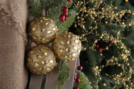 christmas toys on the background of a green Christmas tree with flashlightsの写真素材