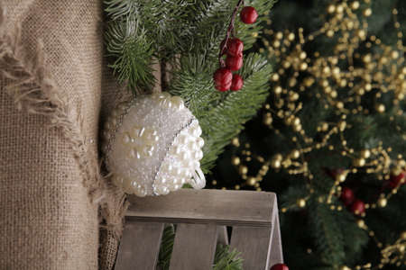 christmas toys on the background of a green Christmas tree with flashlightsの写真素材