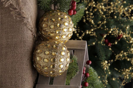 christmas toys on the background of a green Christmas tree with flashlightsの写真素材