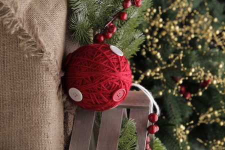 christmas toys on the background of a green Christmas tree with flashlightsの写真素材