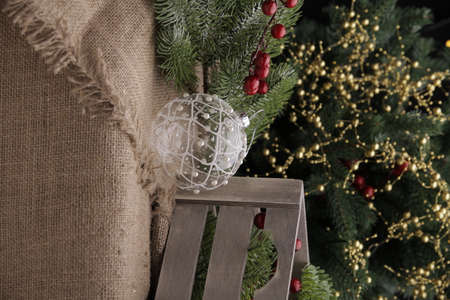 christmas toys on the background of a green Christmas tree with flashlightsの写真素材