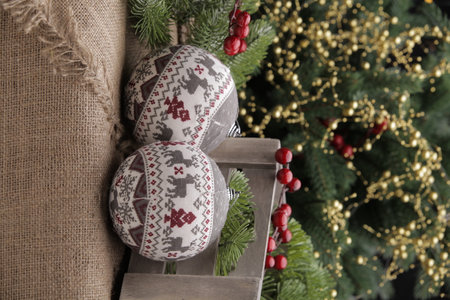 christmas toys on the background of a green Christmas tree with flashlightsの写真素材