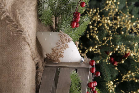 christmas toys on the background of a green Christmas tree with flashlightsの写真素材