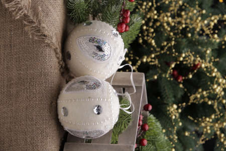 christmas toys on the background of a green Christmas tree with flashlightsの写真素材