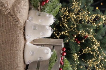 christmas toys on the background of a green Christmas tree with flashlightsの写真素材