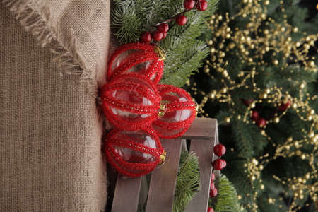 christmas toys on the background of a green Christmas tree with flashlightsの写真素材