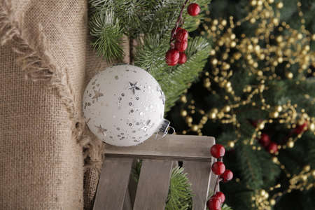 christmas toys on the background of a green Christmas tree with flashlightsの写真素材