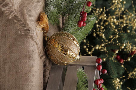 christmas toys on the background of a green Christmas tree with flashlightsの写真素材