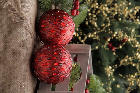 christmas toys on the background of a green Christmas tree with flashlightsの写真素材