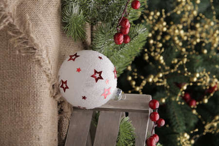 christmas toys on the background of a green Christmas tree with flashlightsの写真素材