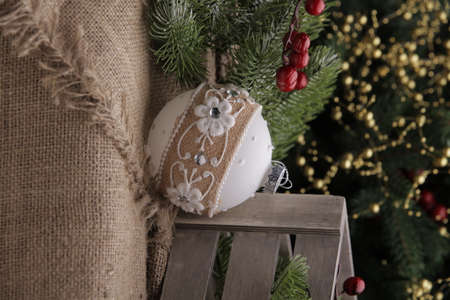 christmas toys on the background of a green Christmas tree with flashlightsの写真素材