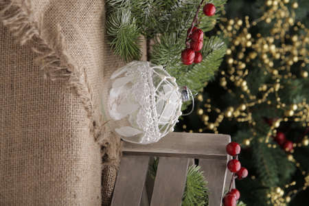 christmas toys on the background of a green Christmas tree with flashlightsの写真素材