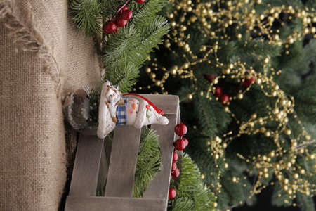 christmas toys on the background of a green Christmas tree with flashlightsの写真素材