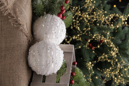 christmas toys on the background of a green Christmas tree with flashlightsの写真素材