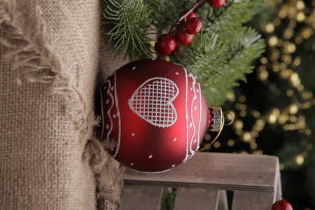 christmas toys on the background of a green Christmas tree with flashlightsの写真素材