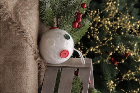 christmas toys on the background of a green Christmas tree with flashlightsの写真素材